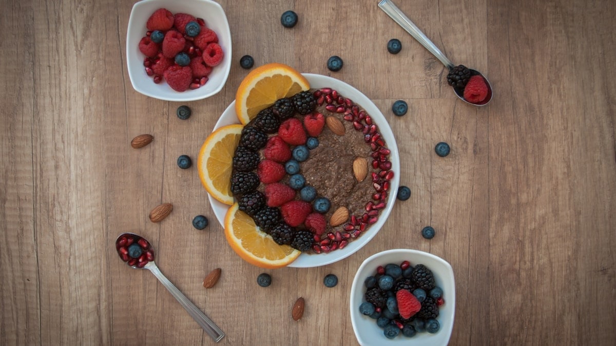 sliced strawberries and blueberries on white ceramic bowl